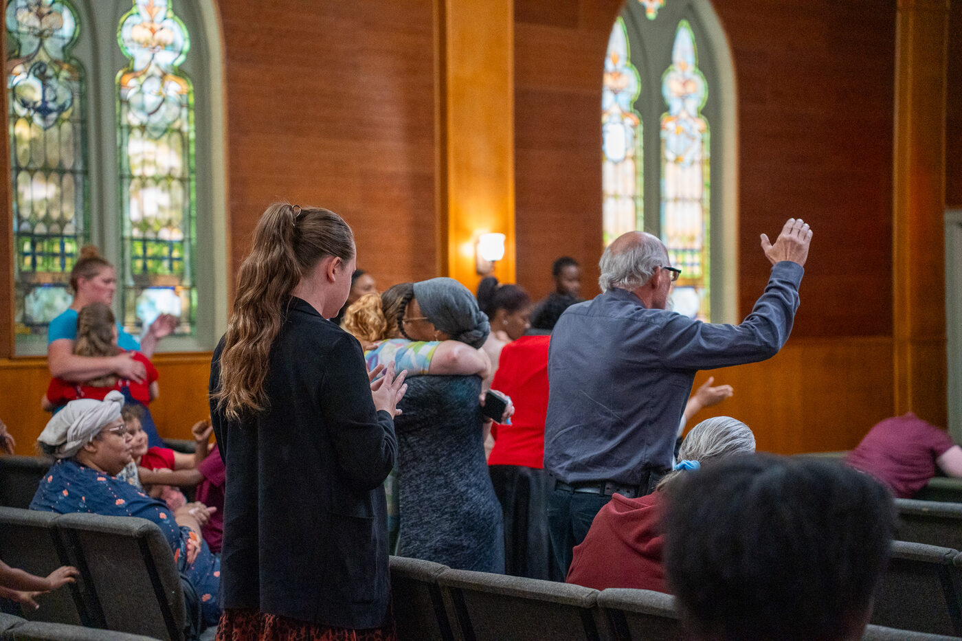 Members of the CLA family embracing during a Sunday gathering