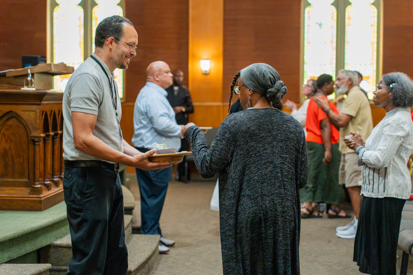 People greeting and connecting during a CLA Sunday gathering